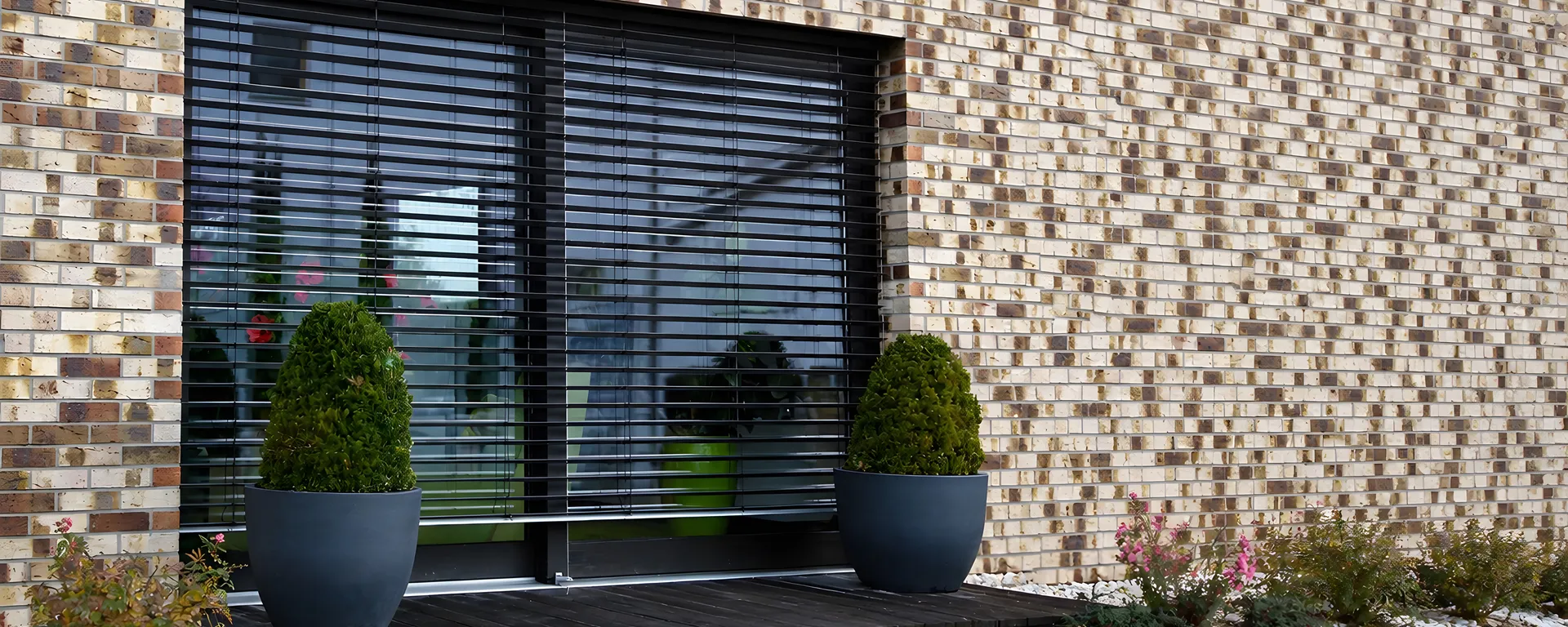Black external Venetian blind fitted across a BizSpace office window