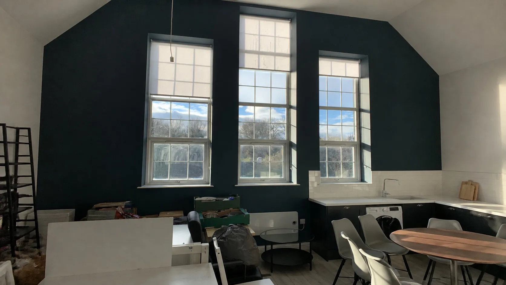 Tall converted-school window fitted with a blind at Brockwood Park