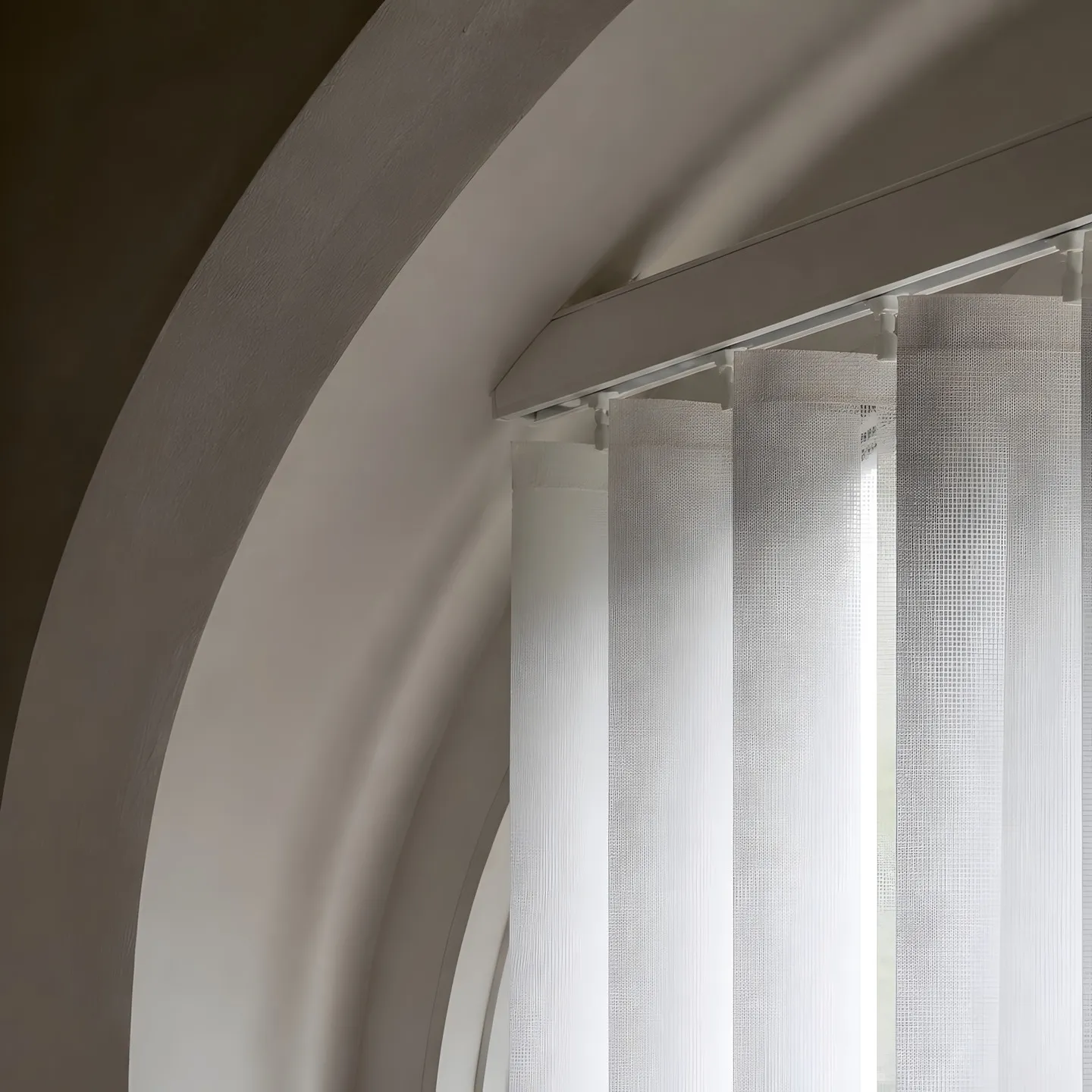 Vertical blinds controlling daylight across tall church windows