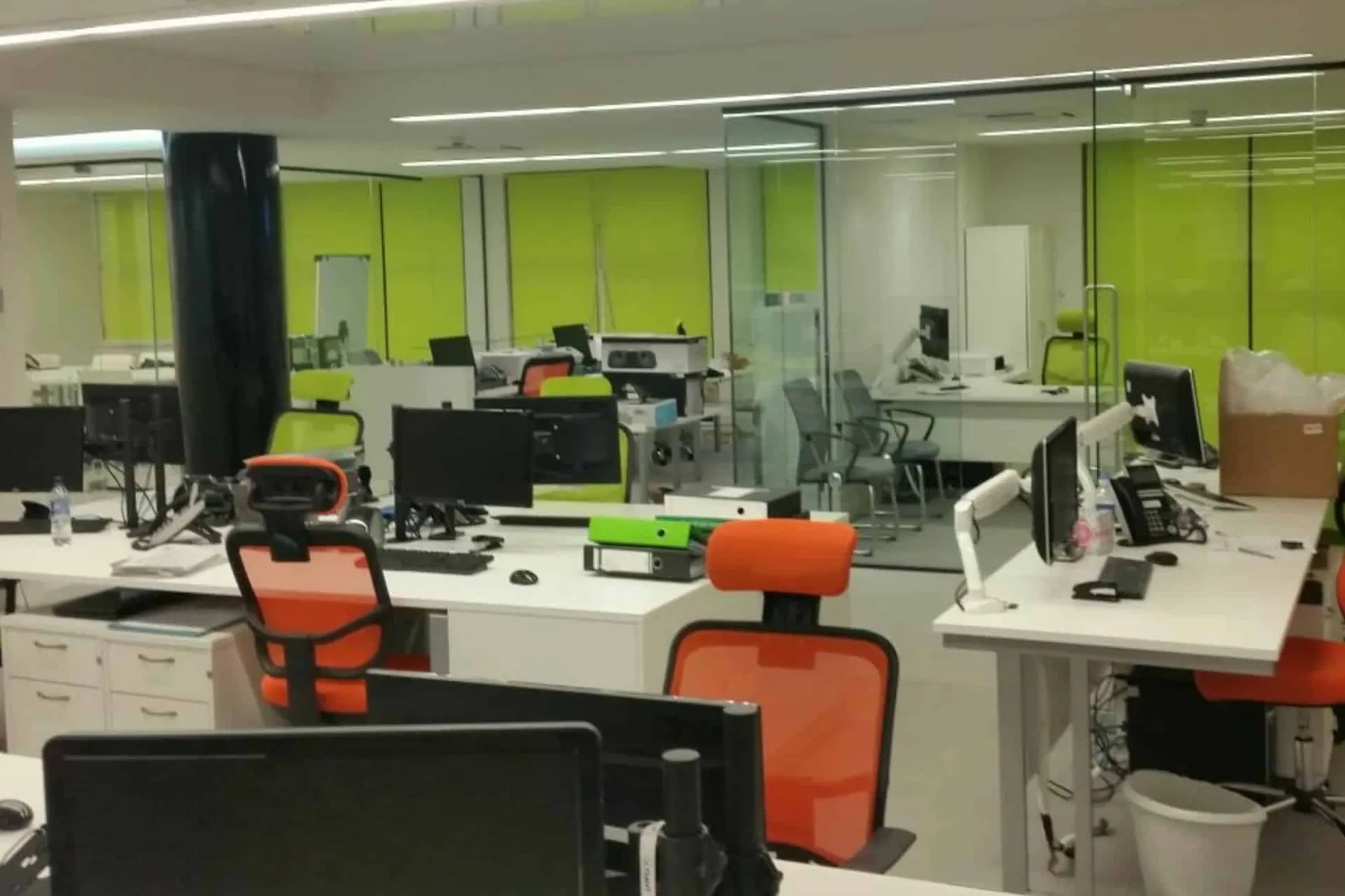 Lime roller blinds fitted across an open-plan Club Systems office
