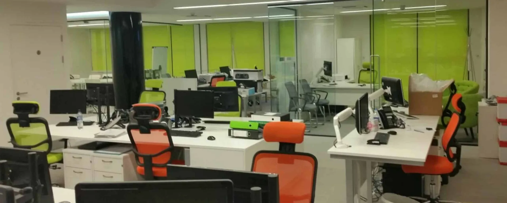Lime roller blinds fitted across an open-plan Club Systems office