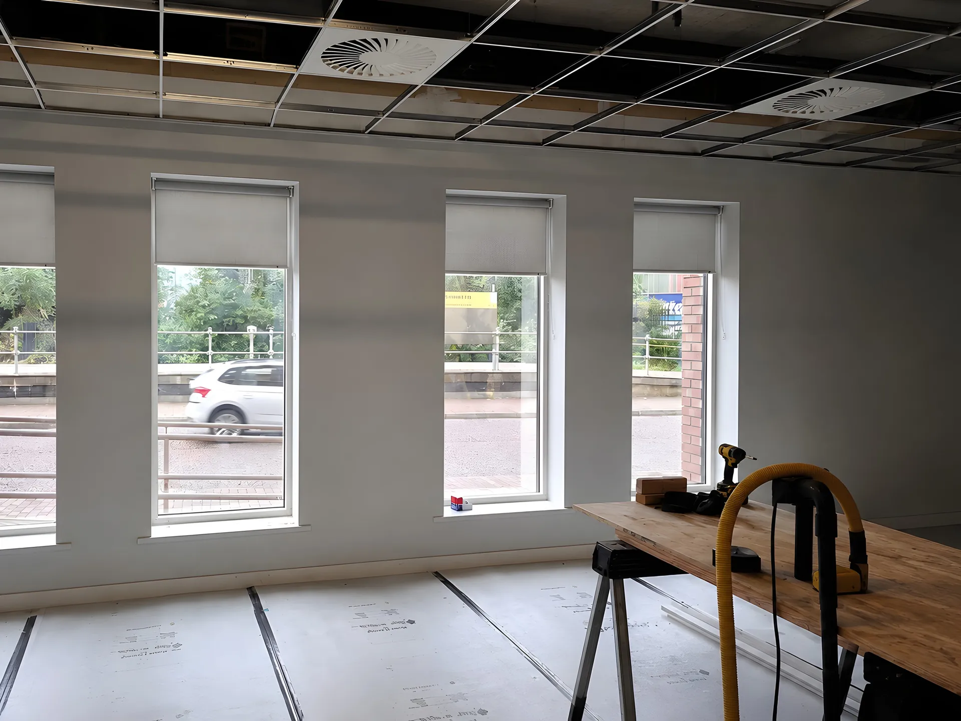 Commercial roller blinds fitted across an office window
