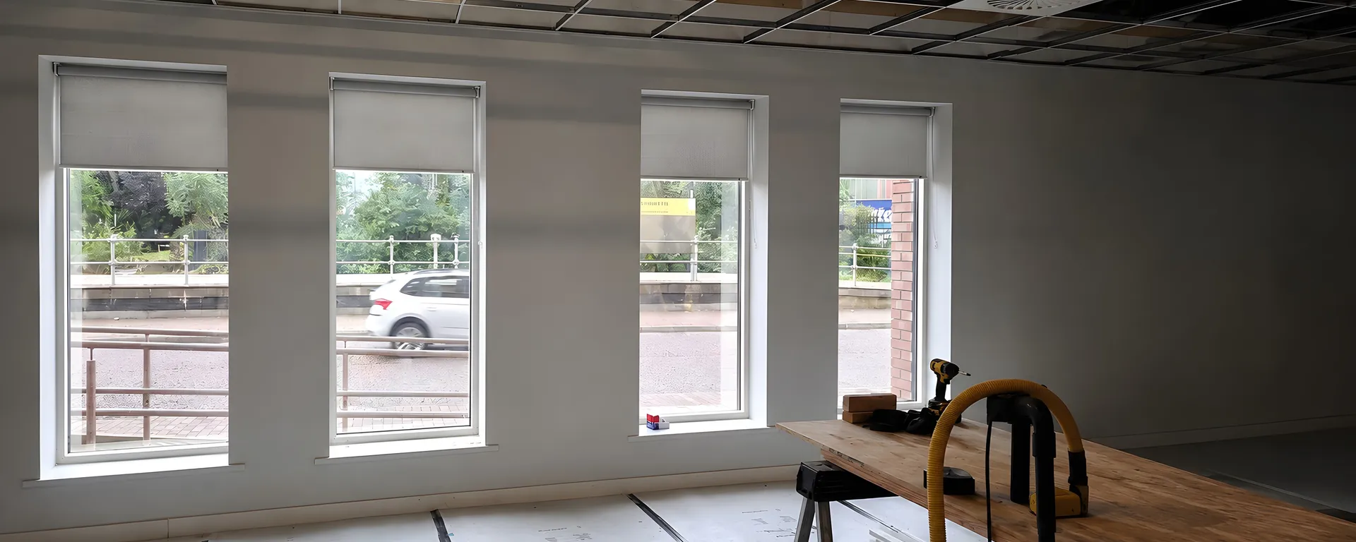 Pale grey roller blinds fitted during the DWP Salford office refurbishment