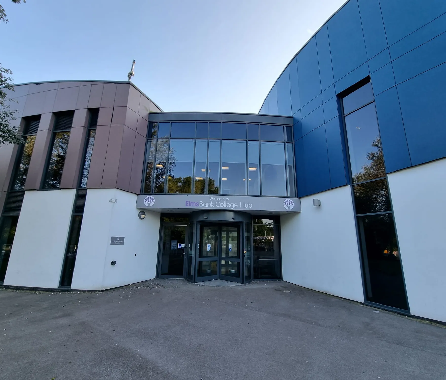 Entrance to Elms Bank College Hub with the Welcome to Elms Bank College Hub sign above the revolving doors