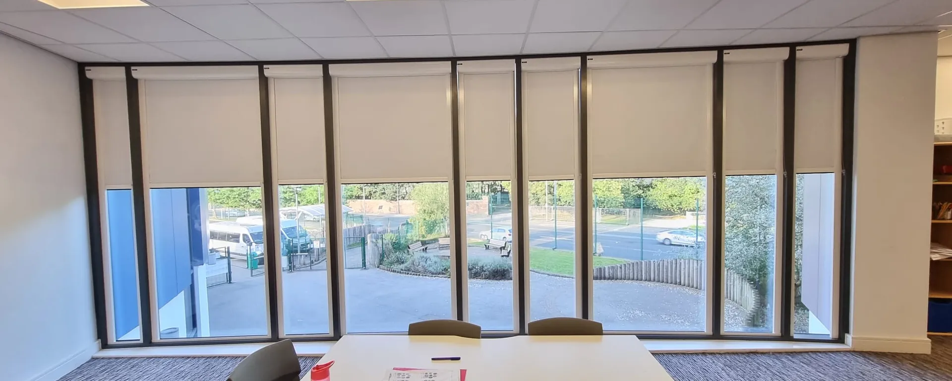 White cassette roller blinds across a full window wall in the learning resource area at Elms Bank College Hub