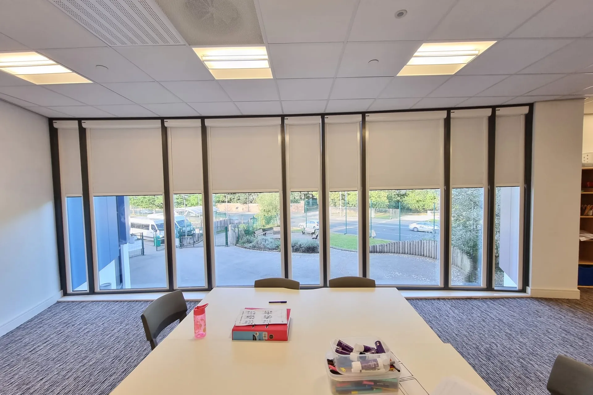 White cassette roller blinds across a full window wall in the learning resource area at Elms Bank College Hub