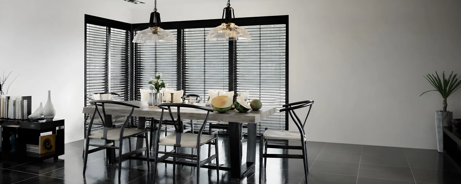 Dark Venetian blinds fitted across the windows of a finished apartment dining room