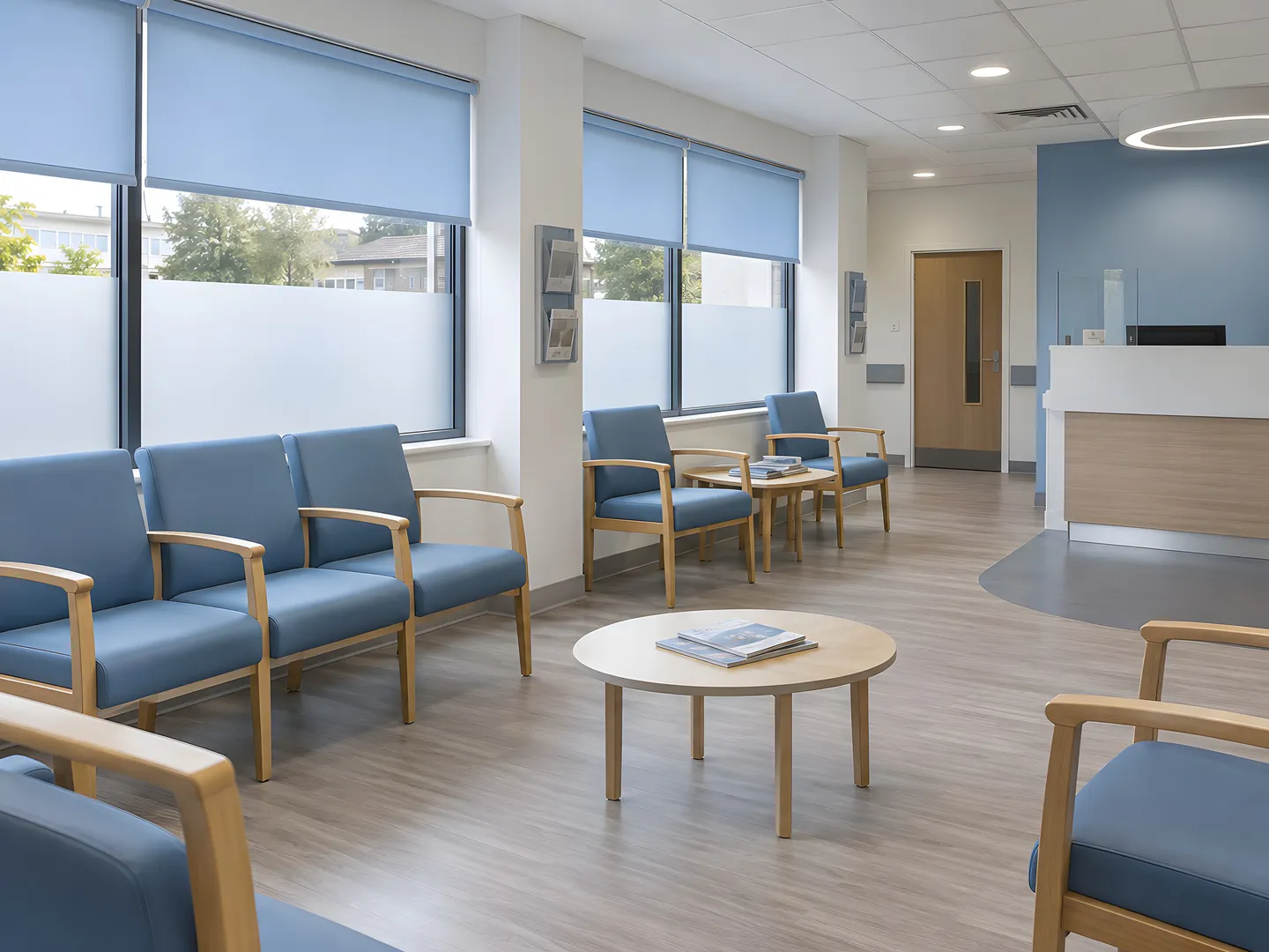 Pale blue roller blinds above frosted glazing in an accessible healthcare waiting room