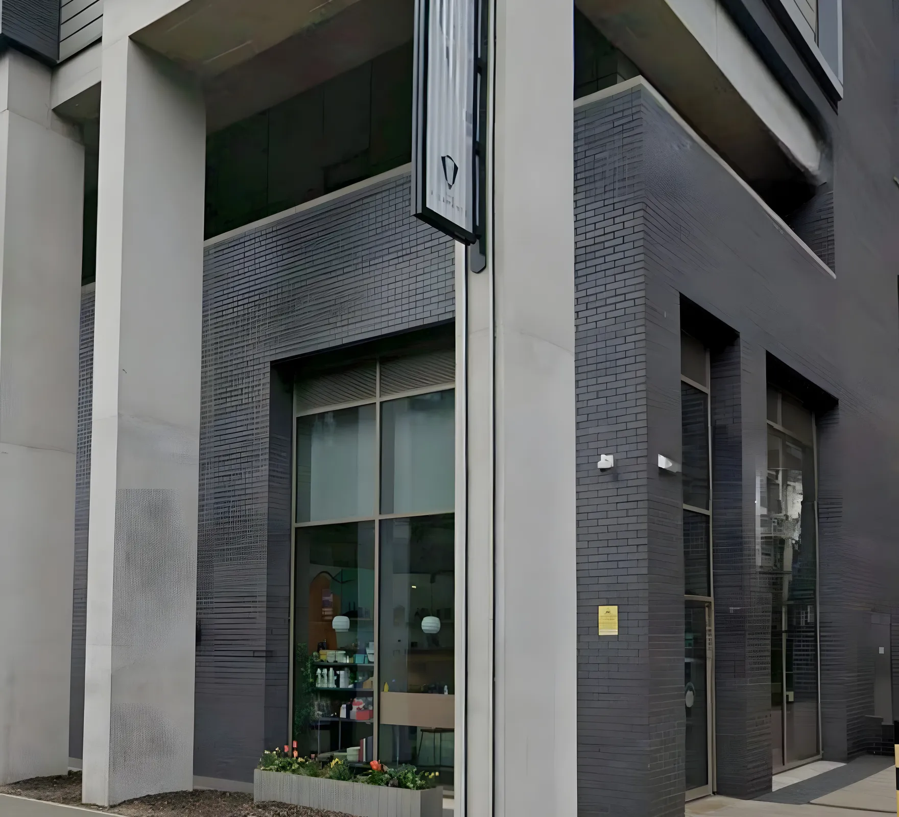 The concrete and glass frontage of Inner West cafe on Chapel Street in Salford