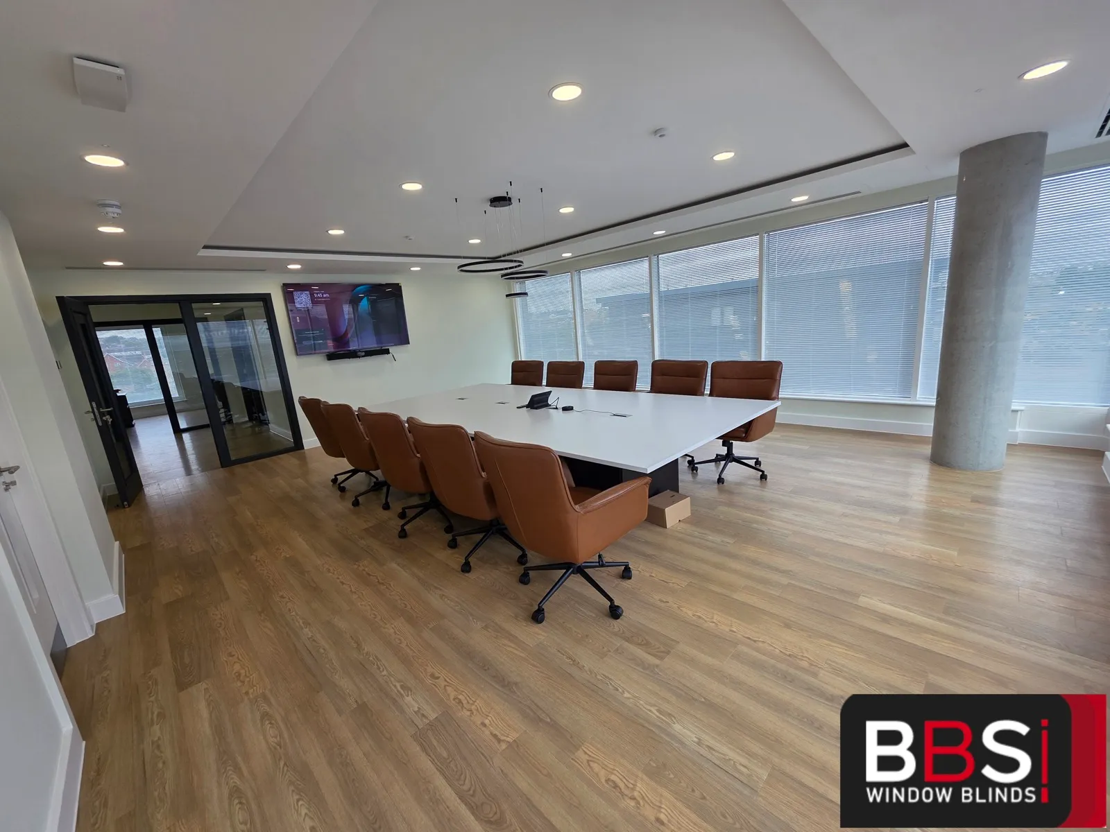 Boardroom at Keady Construction HQ with venetian blinds along the full height glazing