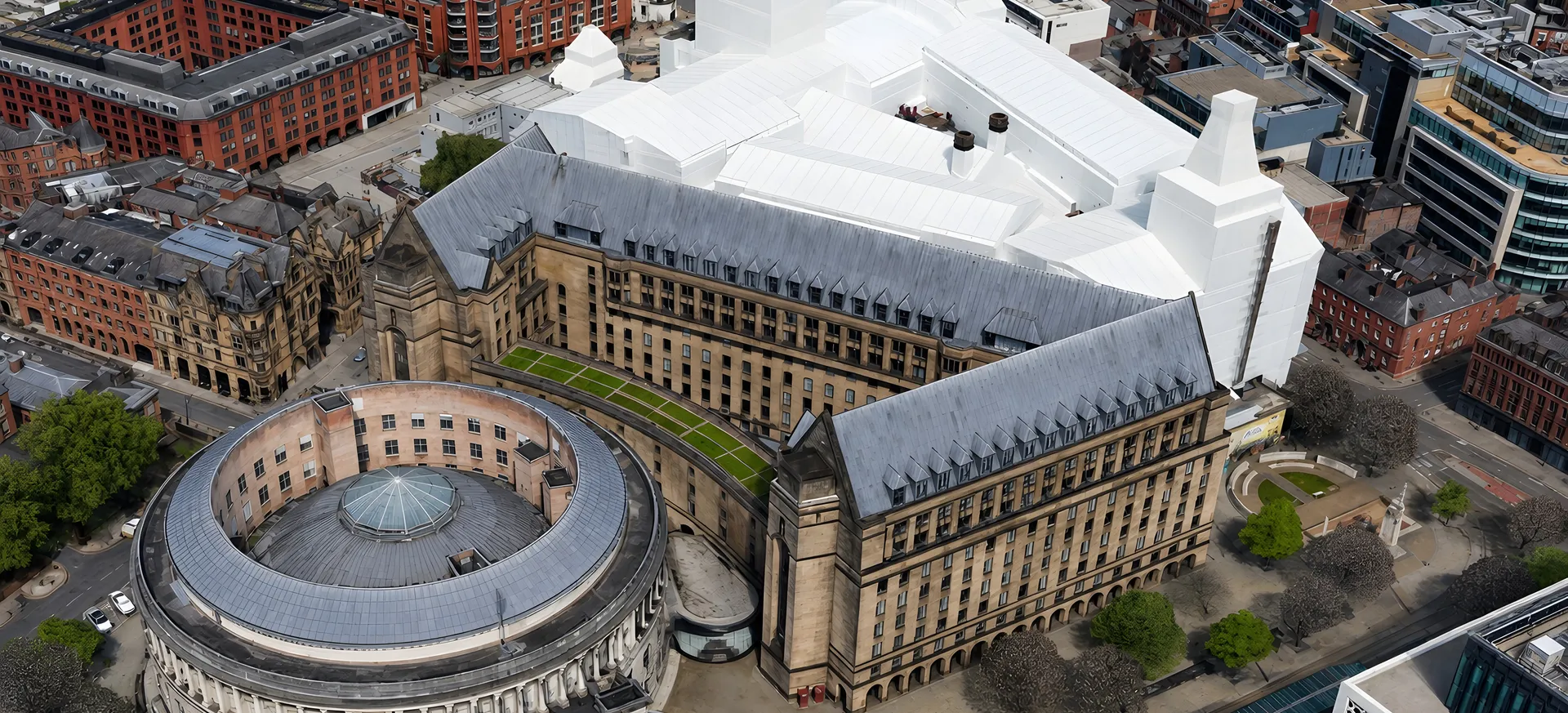 Aerial view across Manchester city centre and the wider urban area