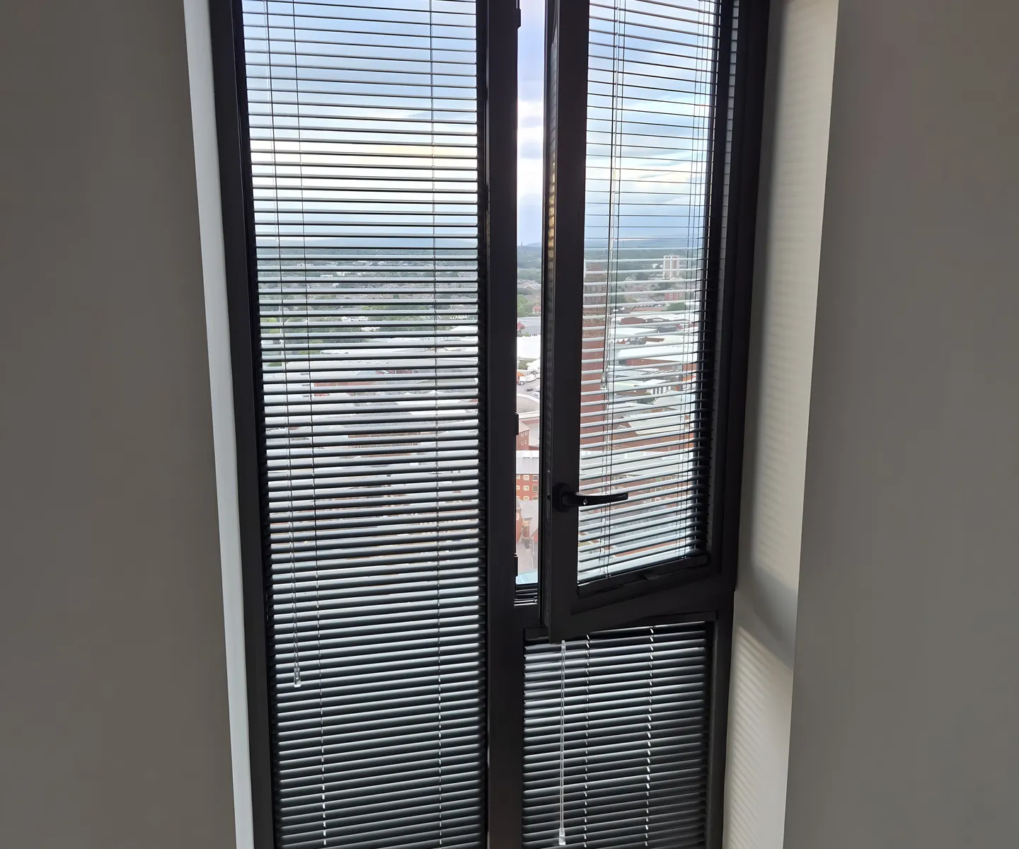 Perfect Fit blind staying on the frame as a tilt-and-turn window swings open