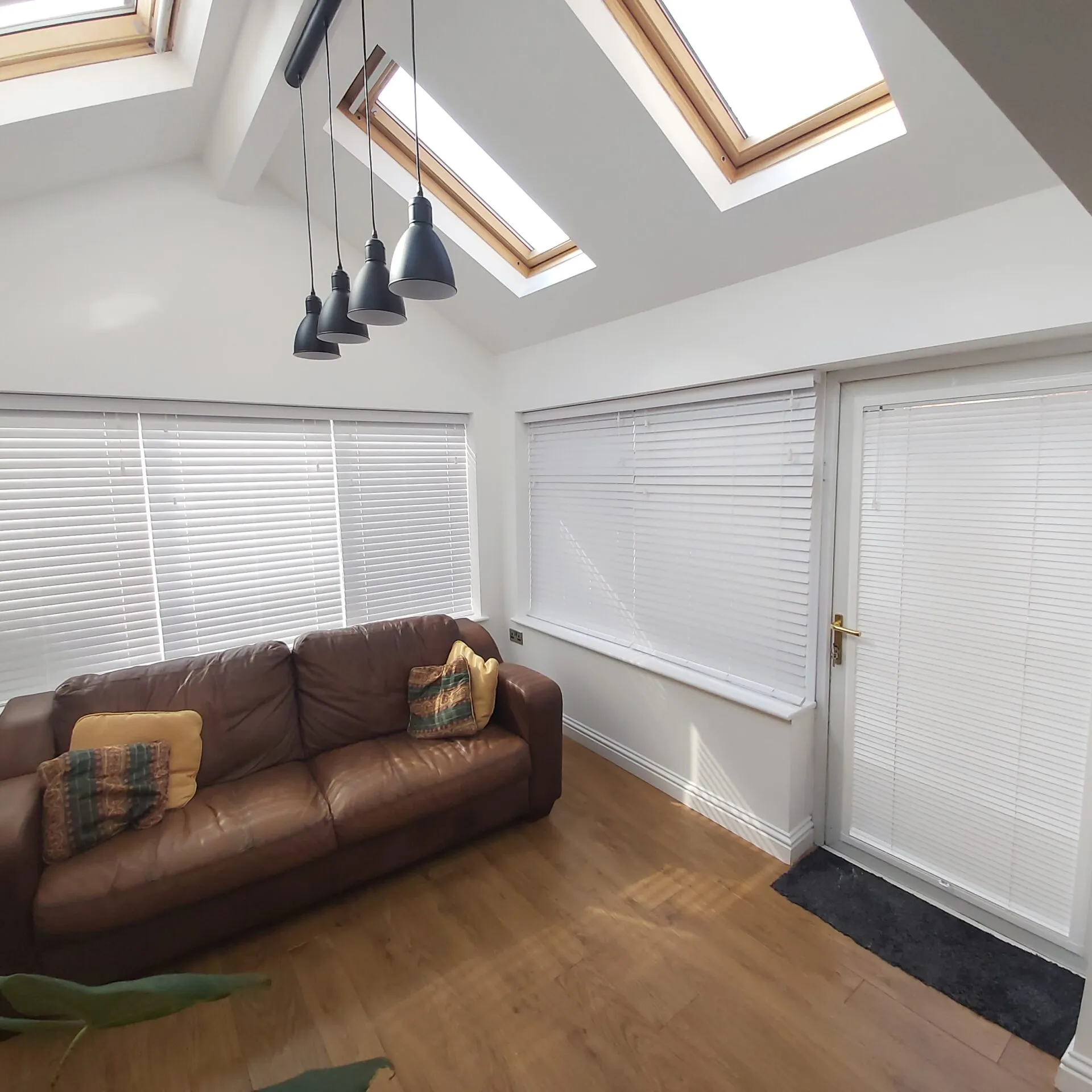 BBS blinds fitted around a furnished conservatory with roof windows