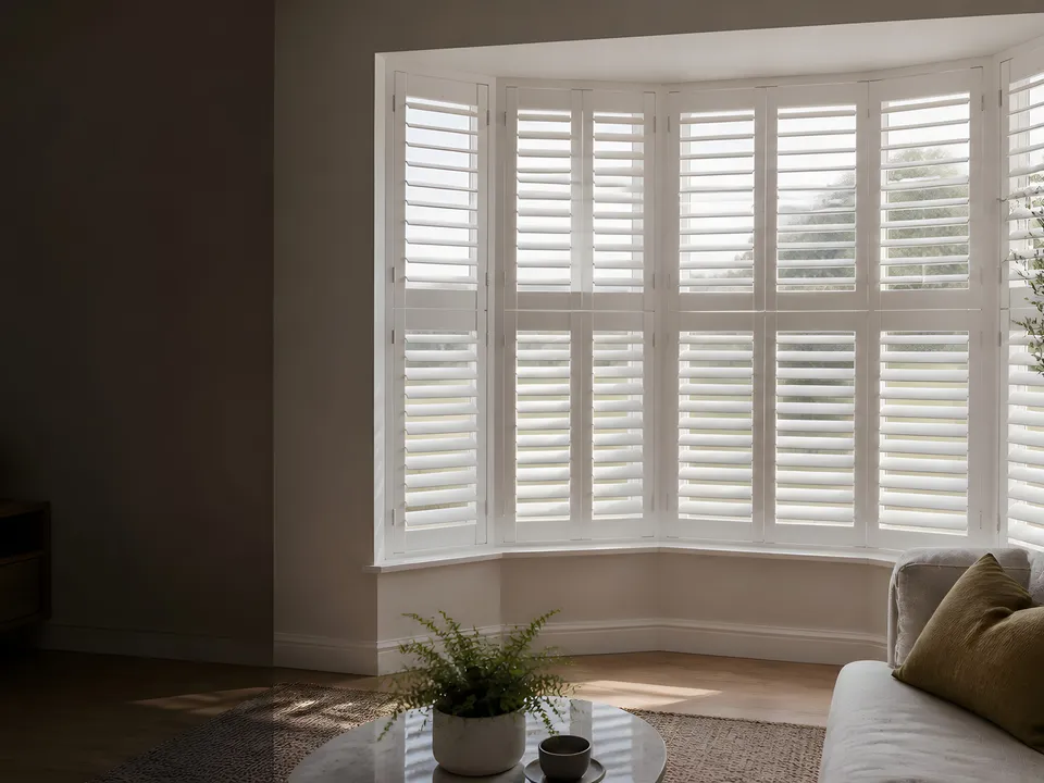 White interior shutters fitted to a bay window