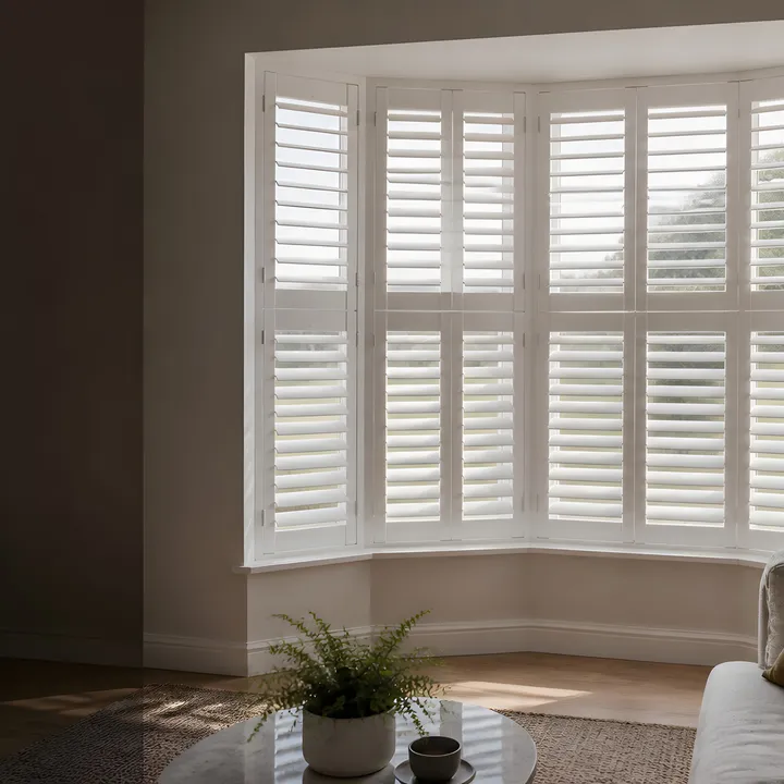 White interior shutters fitted to a bay window