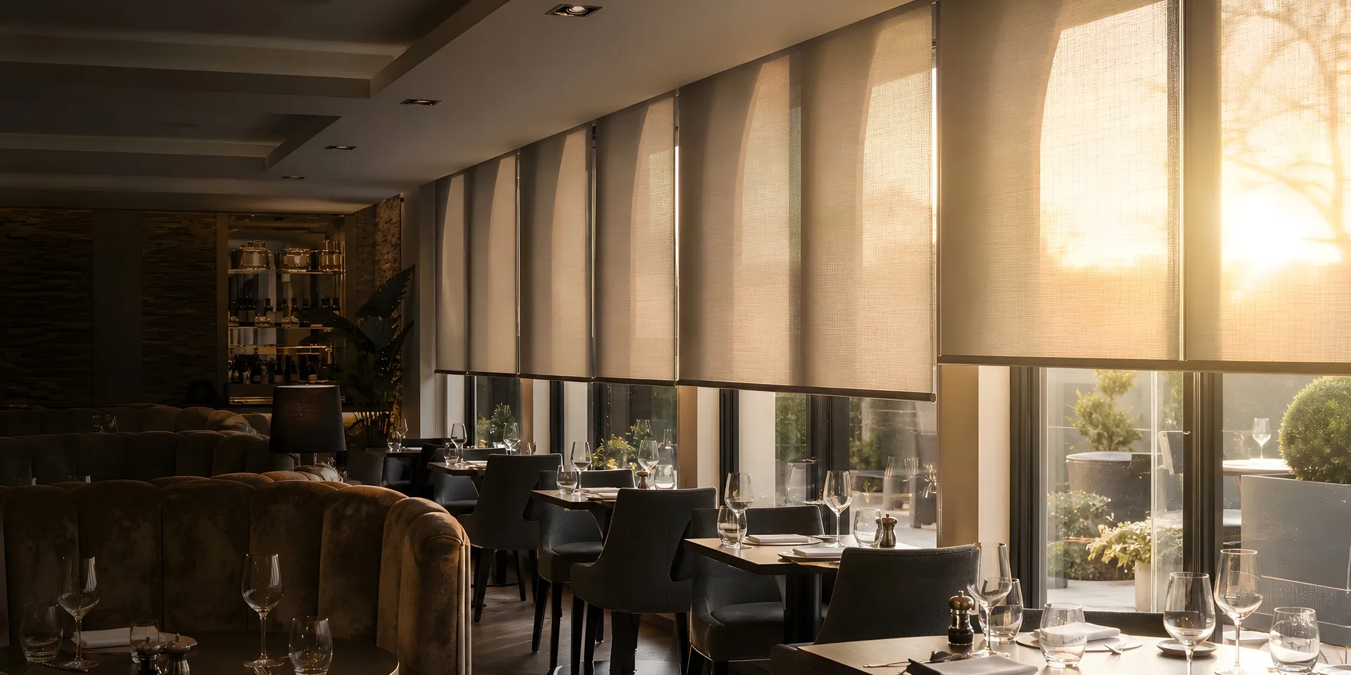 Roller blinds controlling evening light in a British restaurant dining room
