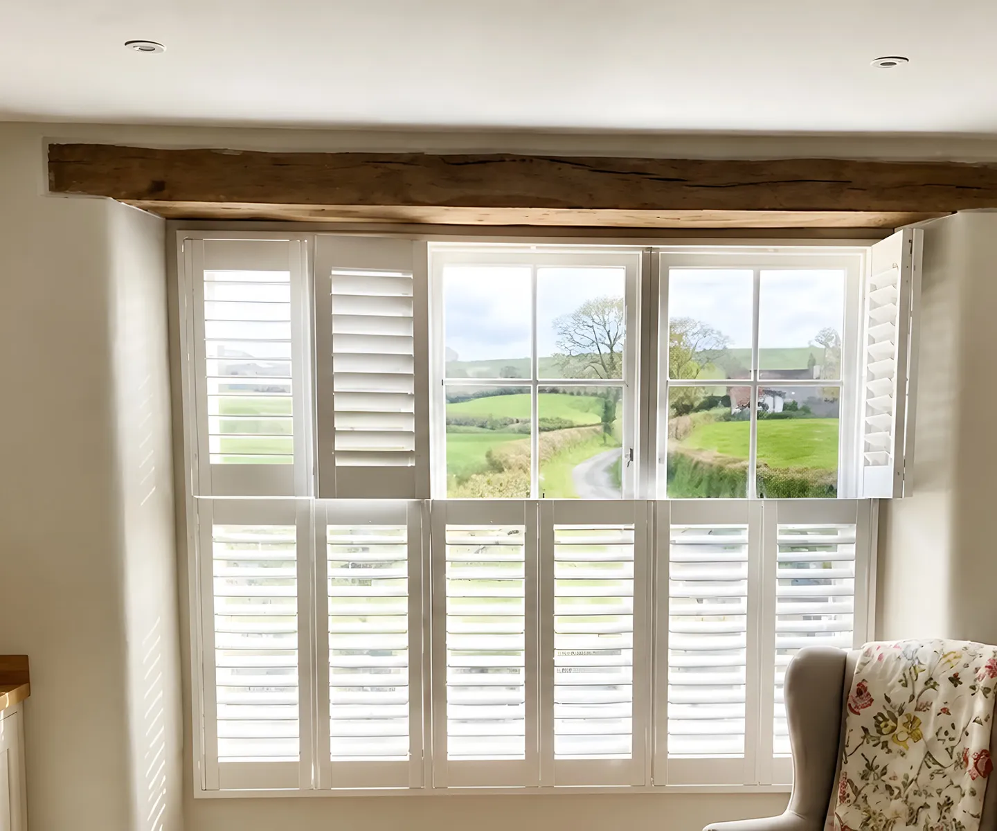 White plantation shutters fitted across a British country kitchen window
