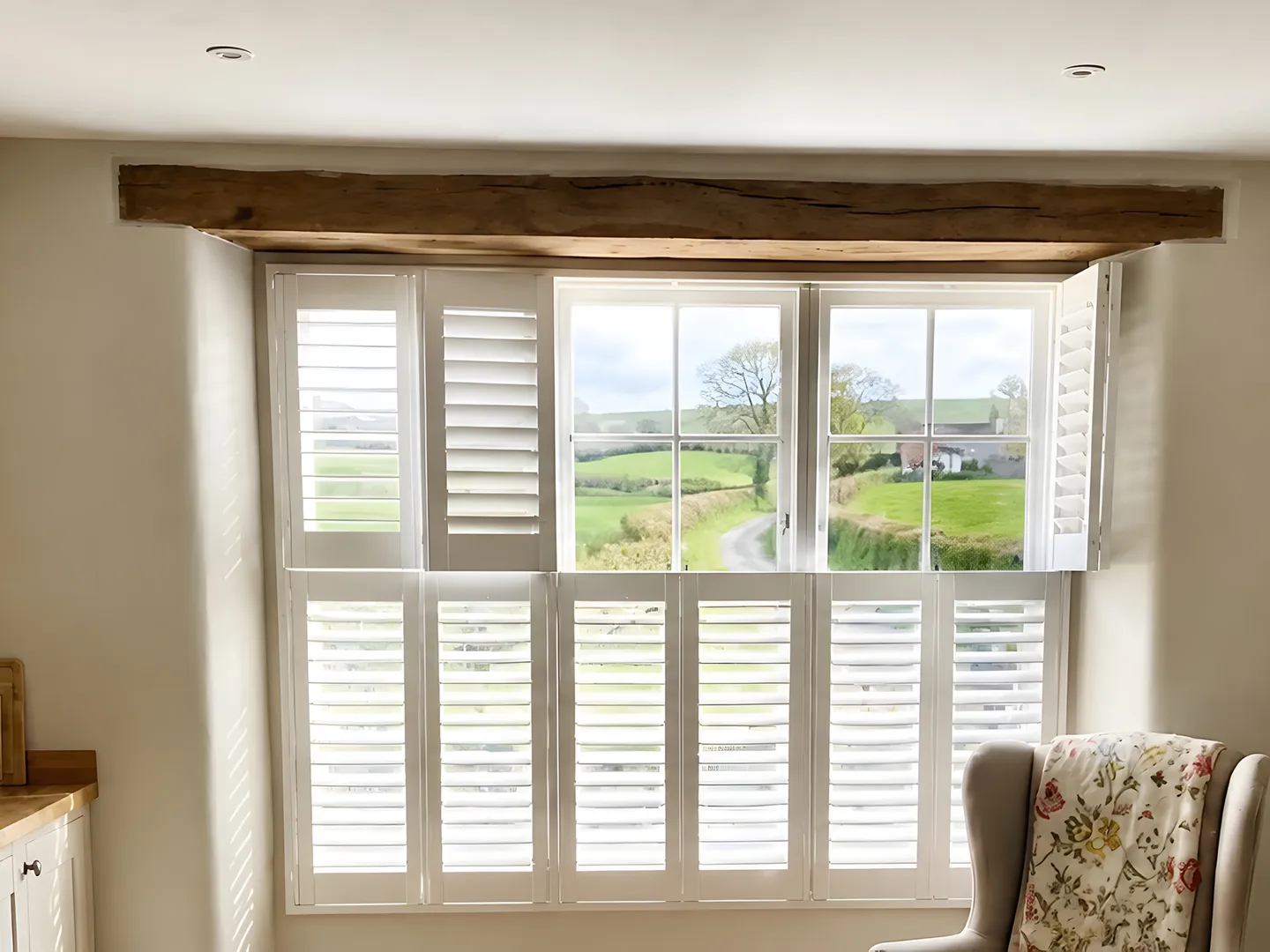White plantation shutters fitted at a country kitchen window