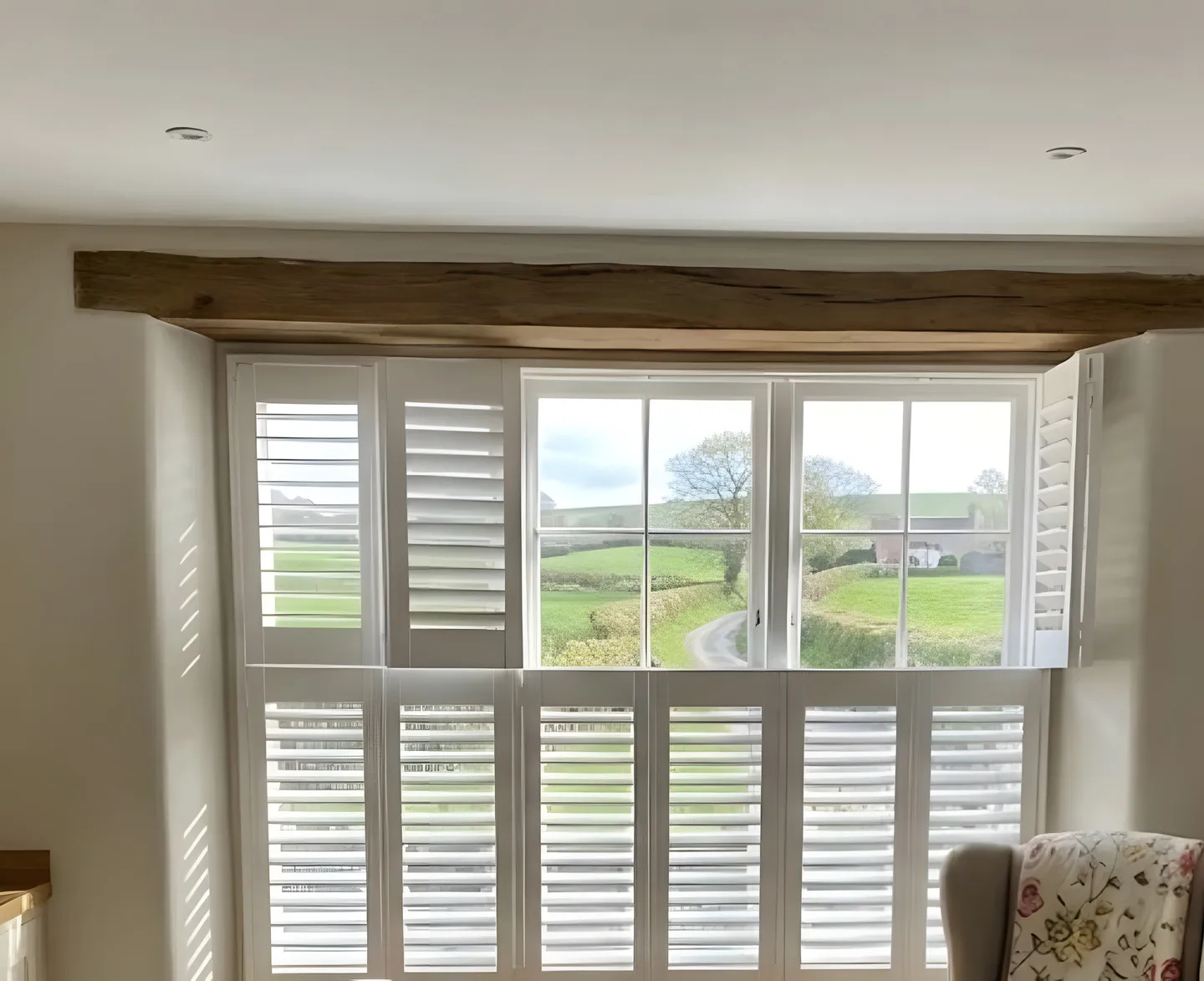 White full-height shutters fitted in a country kitchen
