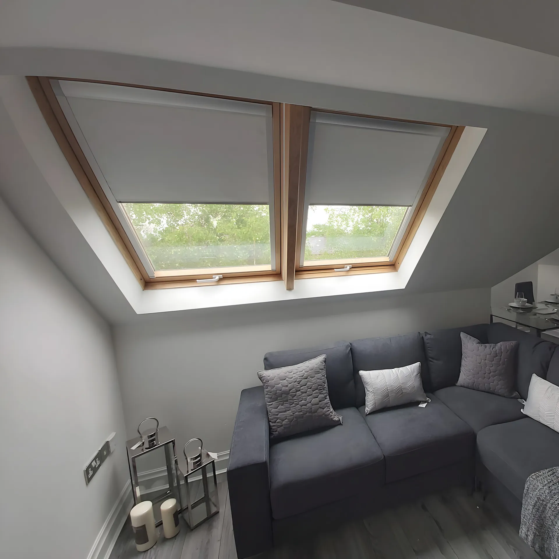 BBS roof window blinds fitted above the sofa in a loft living room