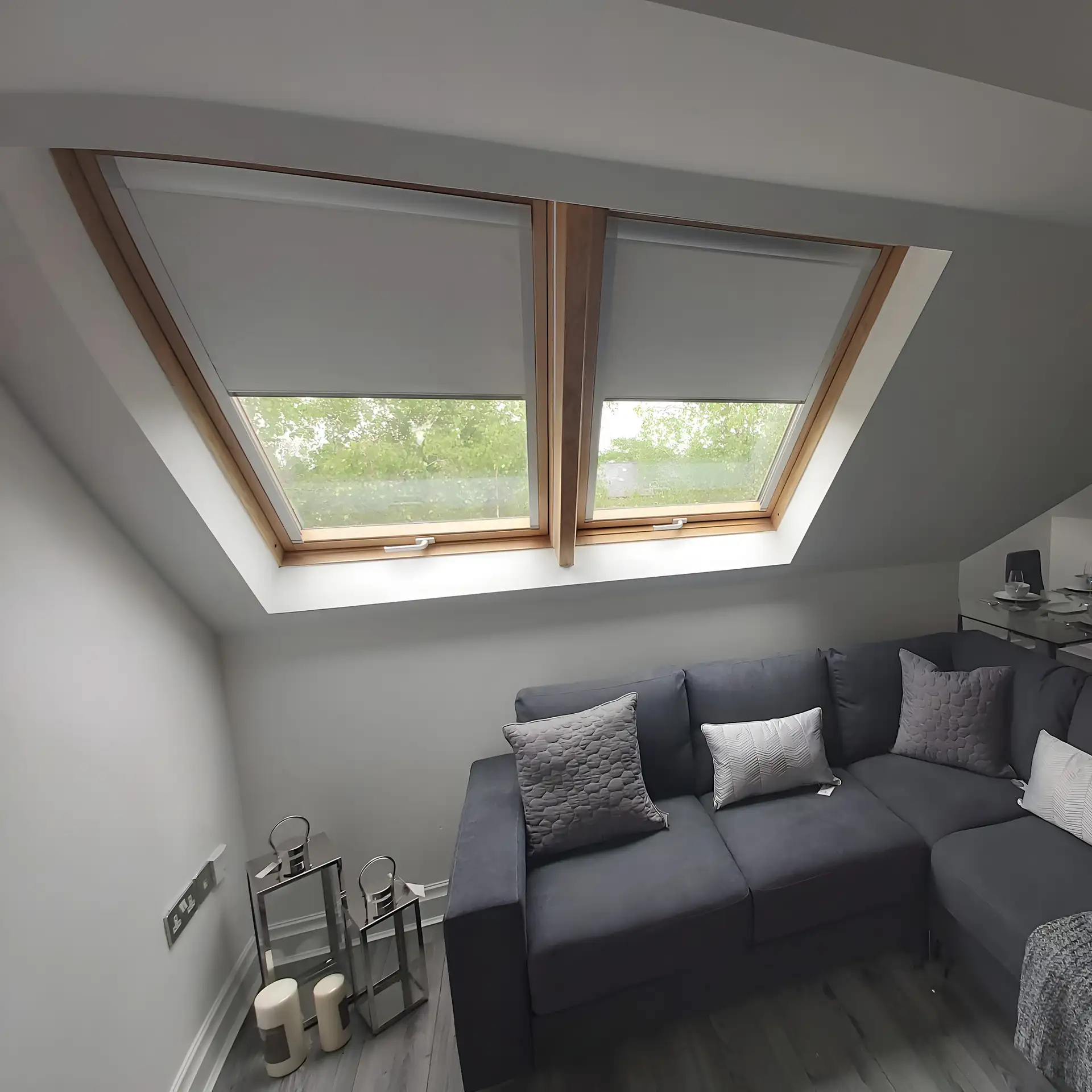 BBS roof window blinds fitted above the sofa in a loft living room