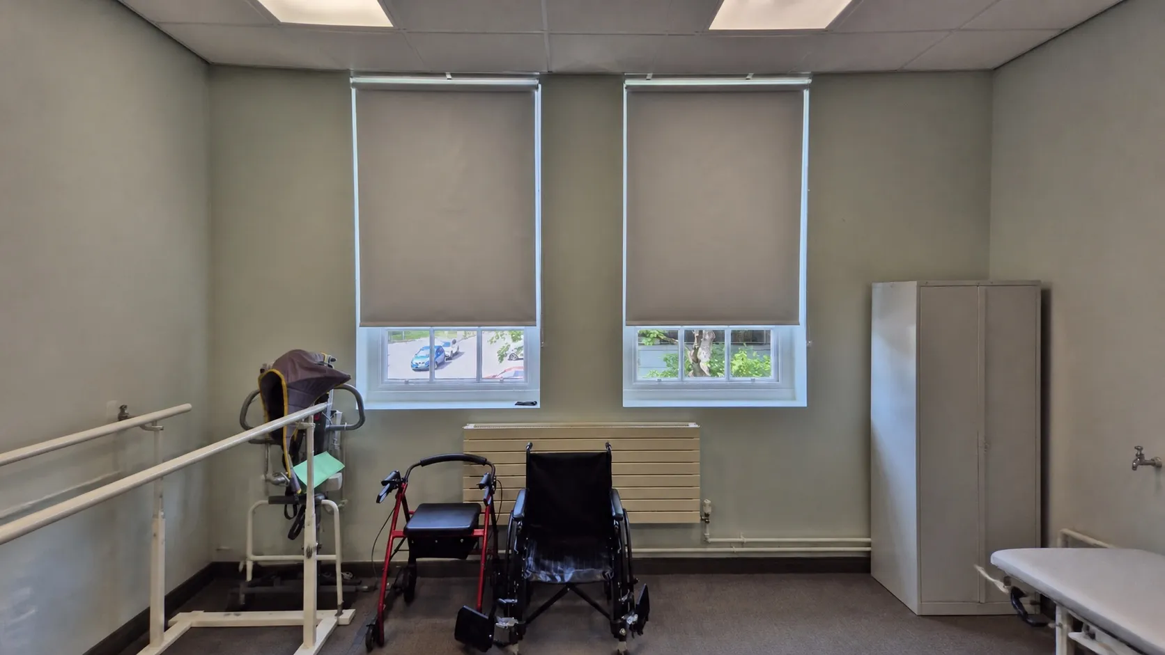 Pair of white PVC blackout blinds above mobility training equipment in a college teaching room