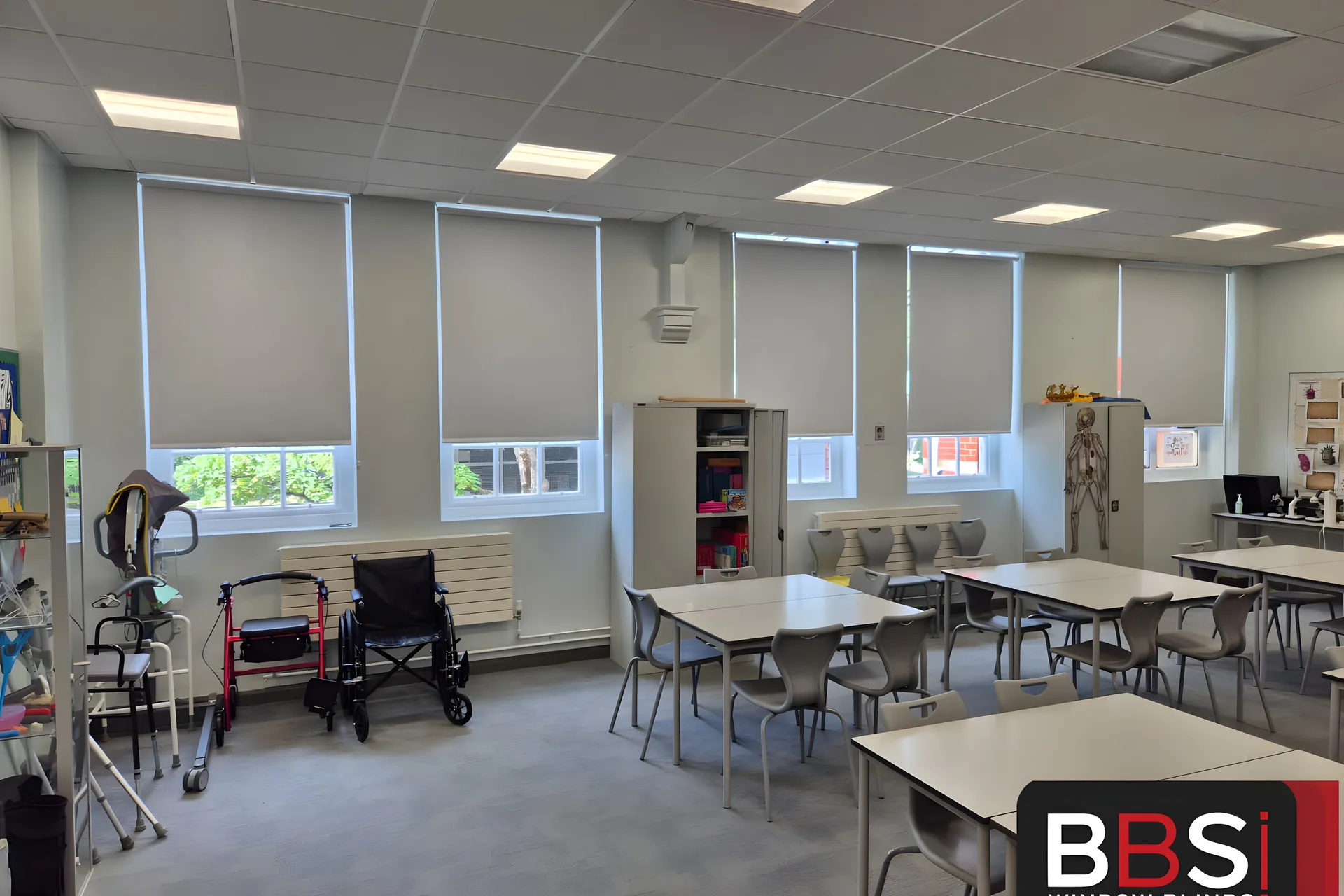 Health and social care training room at Worsley College with a run of white PVC blackout blinds above wheelchair and walking frame equipment